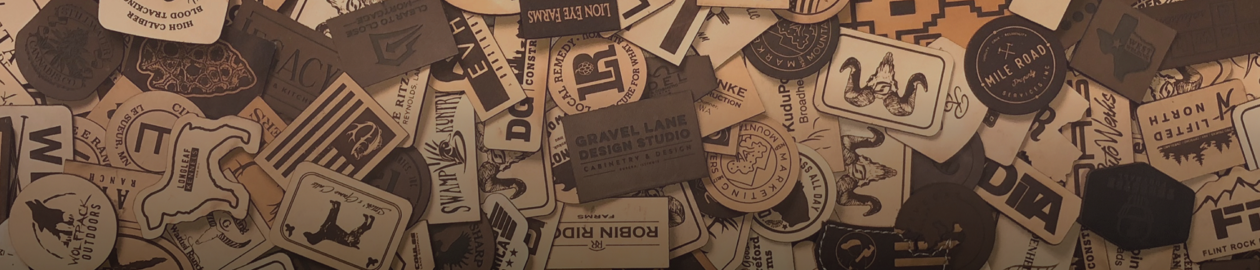 banner of a bunch of natural, brown and black leather patches layed out