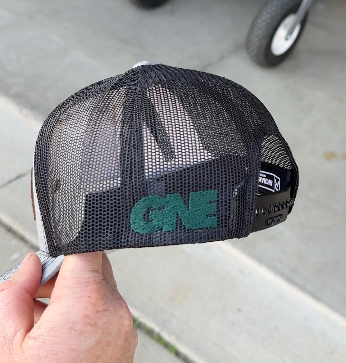 GNE embroidered on the side of a heather black hat
