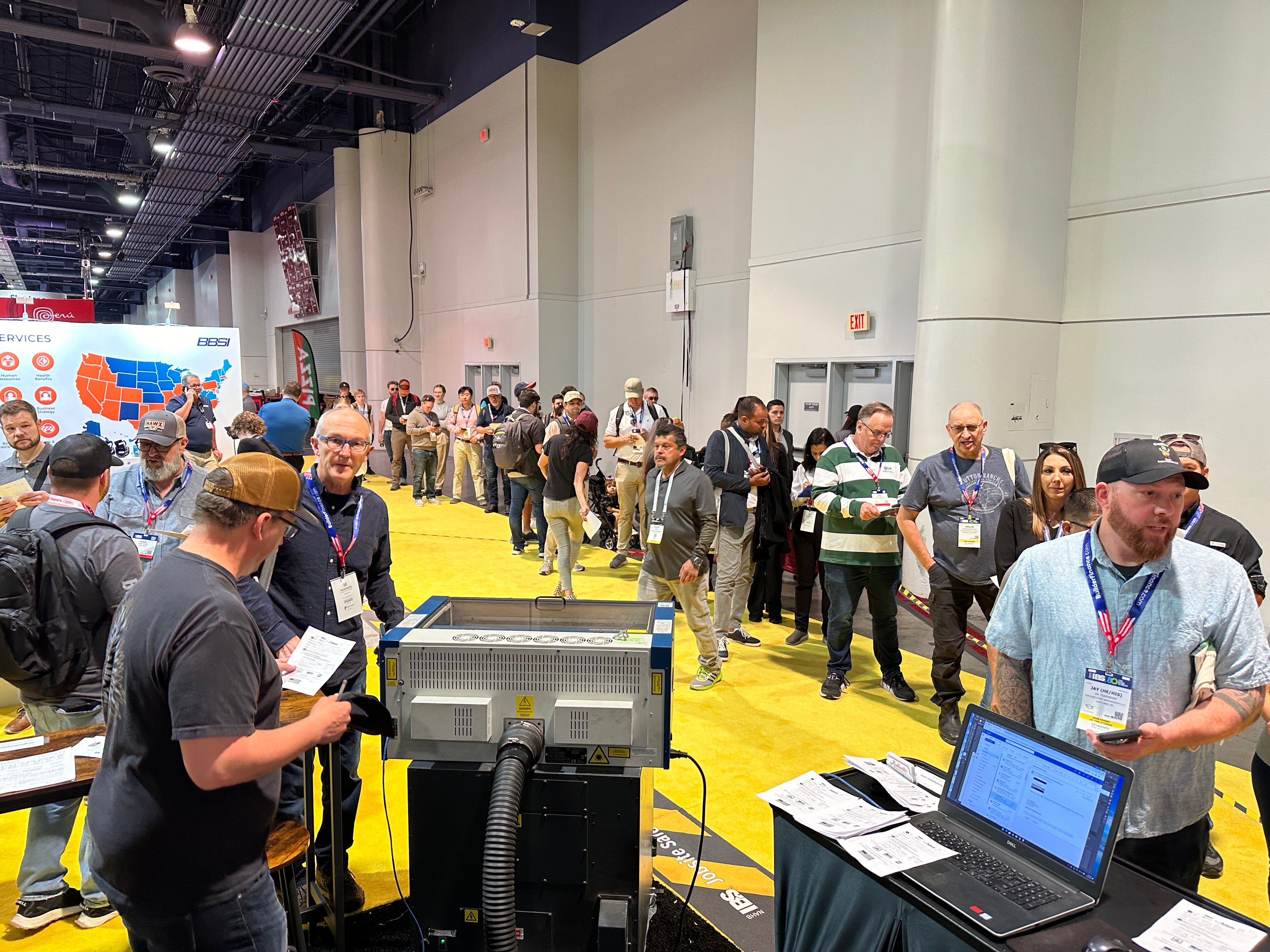 A large line of people waiting to get their own custom leather patch hat made at the IBS show in Las Vegas