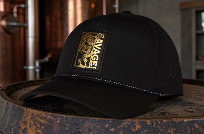 Savage Craft gold foil leather patch hat sitting in the brewery room