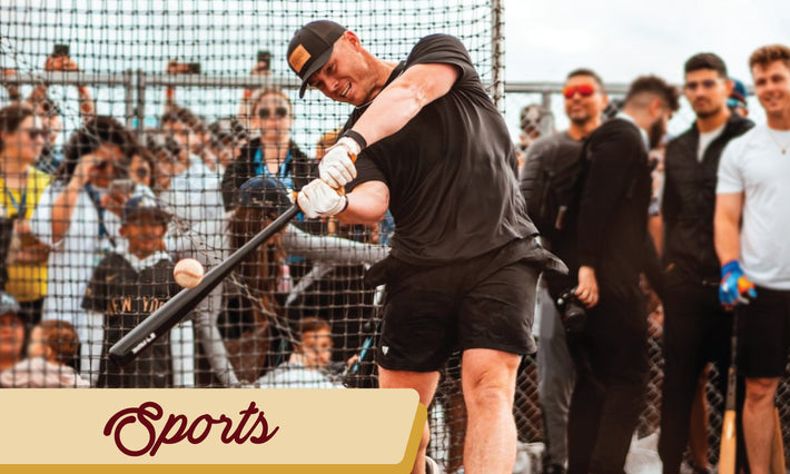 Custom leather patch hat featured on a man doing batting practice while people watch in the background