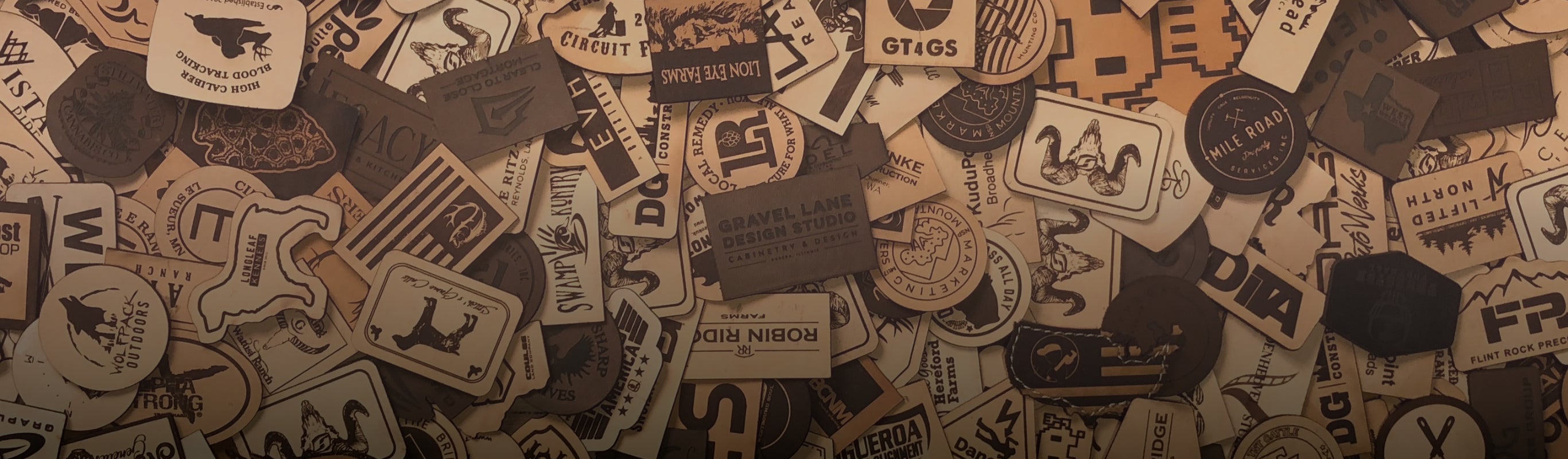 A bunch of custom leather patches layed out with natural, brown and black leather